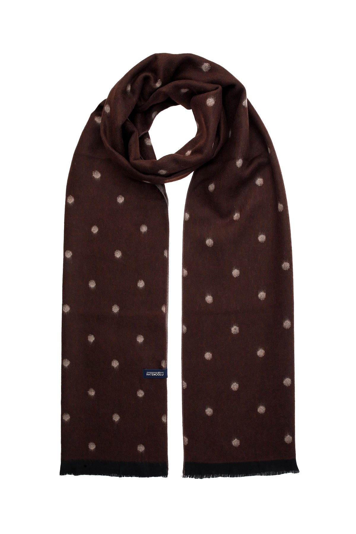 A brown scarf with a subtle pattern of light-colored polka dots, featuring frayed edges and a small brand tag near the bottom.