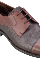 Brown leather oxford shoe with a pebbled texture on the main body and smoother panels, featuring matching laces.