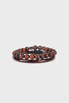 A sleek, two-layered bracelet featuring polished tiger eye beads with a rich amber and dark brown swirl pattern, accented by a matte black magnetic clasp.
