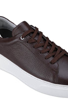 Brown leather low-top sneaker with a white rubber sole and matching brown laces.