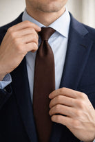 A sleek solid brown silk tie with smooth texture and classic pointed tip casual 2.36 inches brown tie