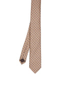 A beige silk tie with a subtle pattern of dark brown polka dots.