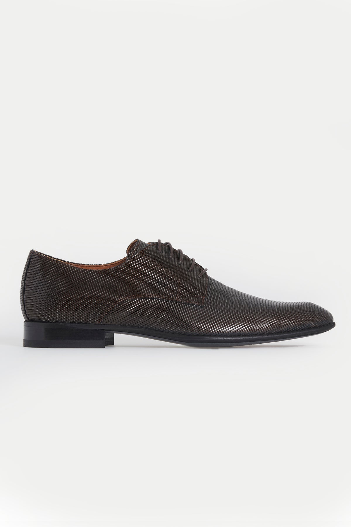Dark brown textured leather lace-up oxford shoe with a classic pointed toe and black sole.