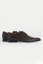 Black perforated leather men’s dress shoes with a classic oxford design and dark laces.