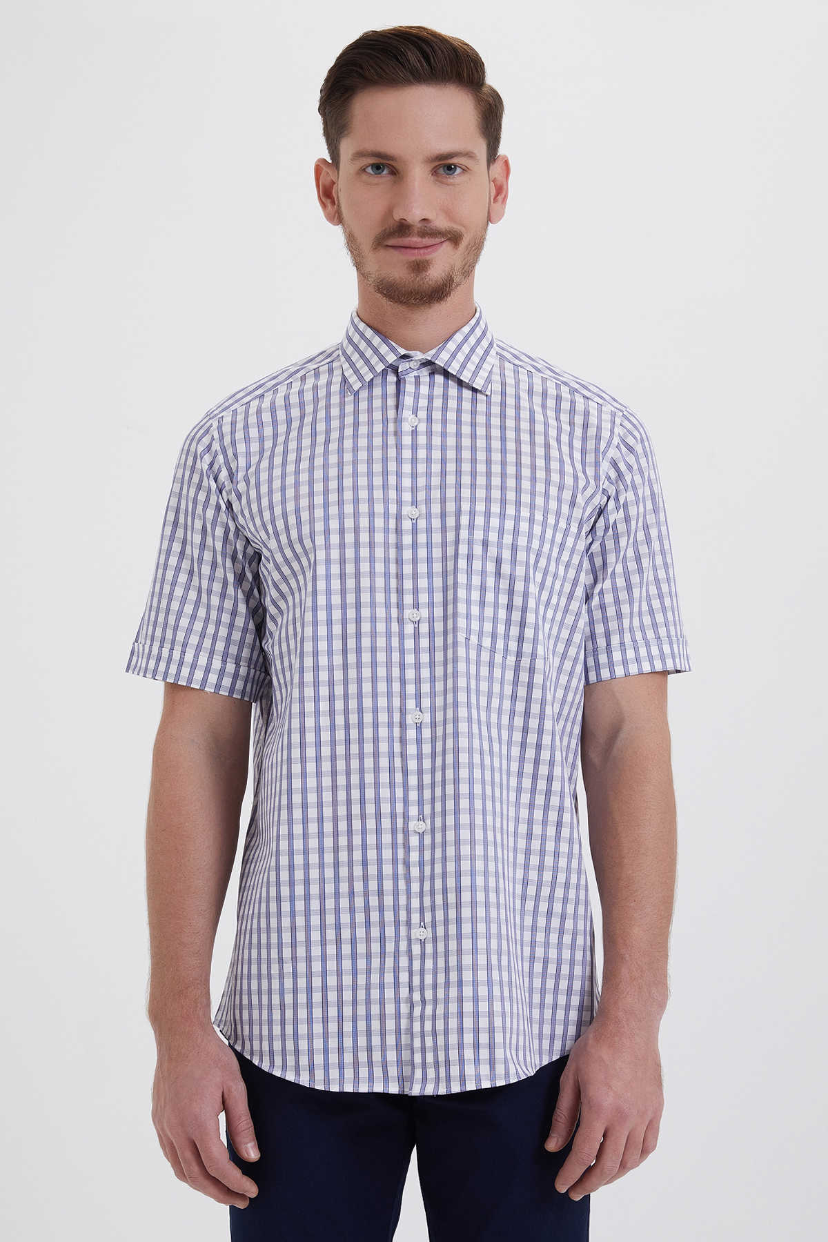 A man wearing a short-sleeved button-up shirt with a blue and white checkered pattern.