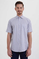 A man wearing a short-sleeved button-up shirt with a blue and white checkered pattern.