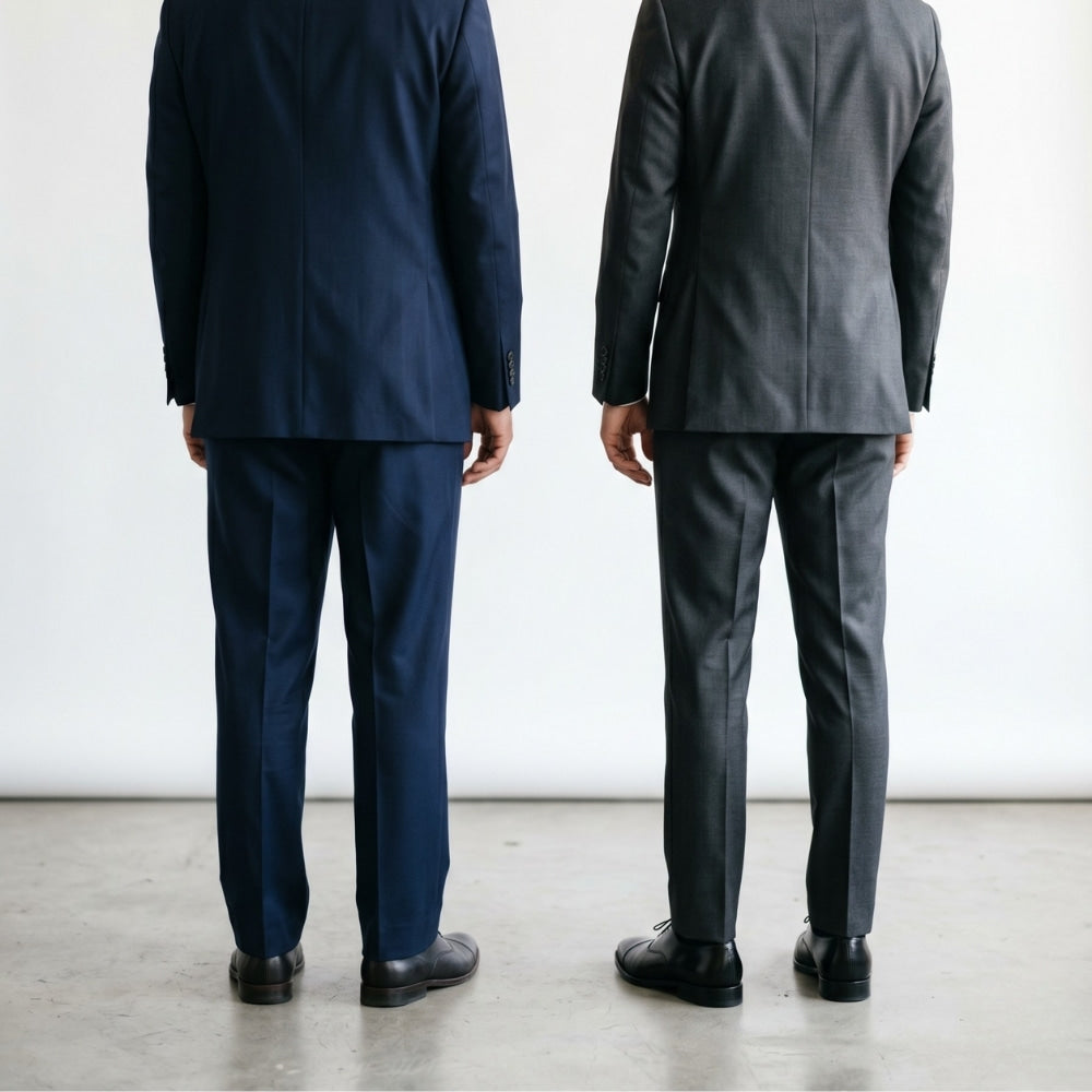Rear three-quarter view of two men comparing the back silhouette of a classic fit suit and a regular fit suit showing the difference in waist suppression