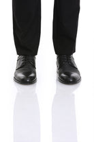 Black leather lace-up dress shoes with a polished toe cap and subtle textured panels.