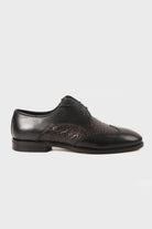 Black leather oxford shoe with a textured, dark brown crocodile-patterned panel on the toe and side.