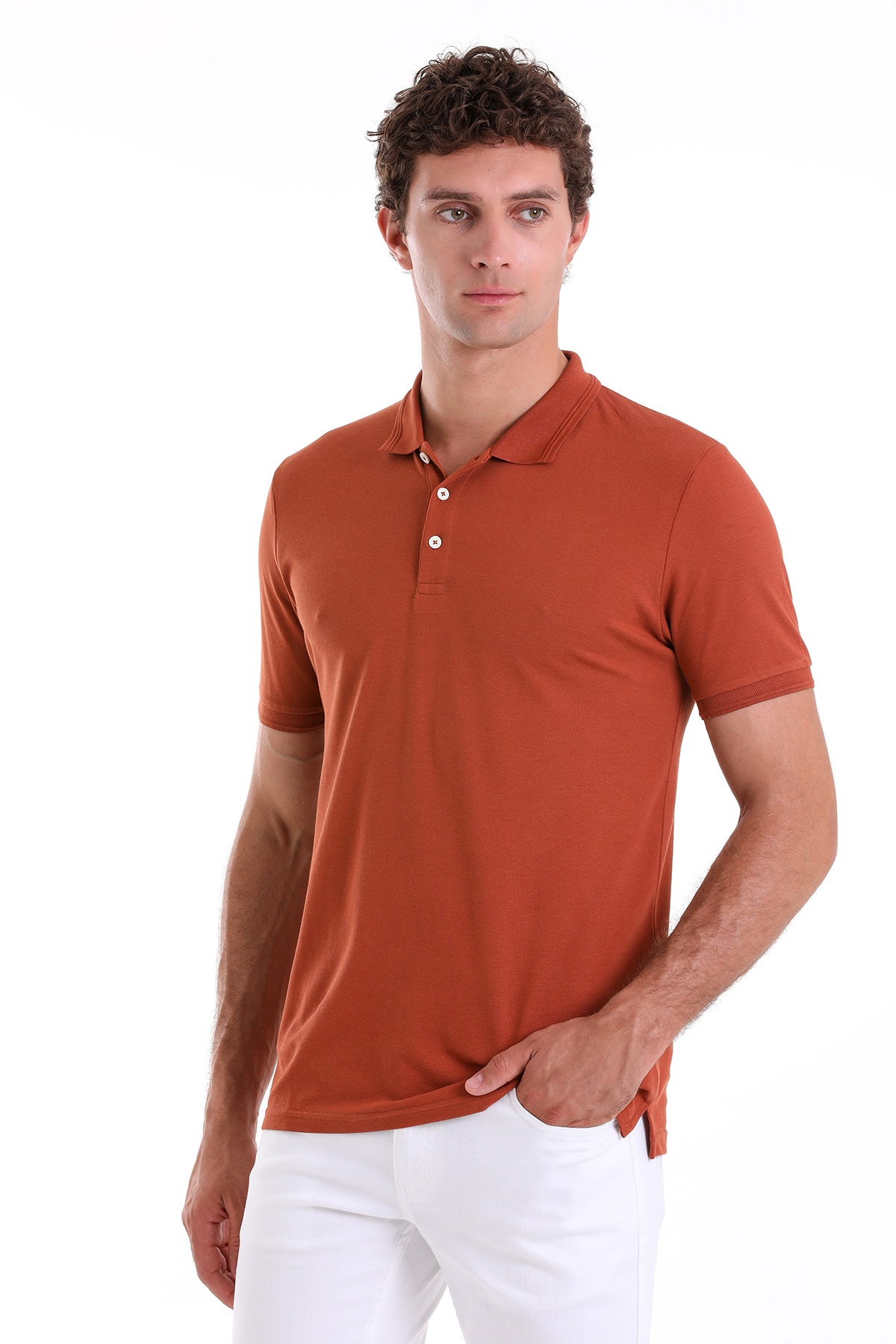 A man wearing a rust-colored, short-sleeved polo shirt with white buttons and a ribbed collar.