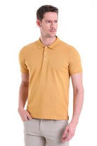 A men’s mustard-yellow short-sleeved polo shirt with a classic collar and white buttons.