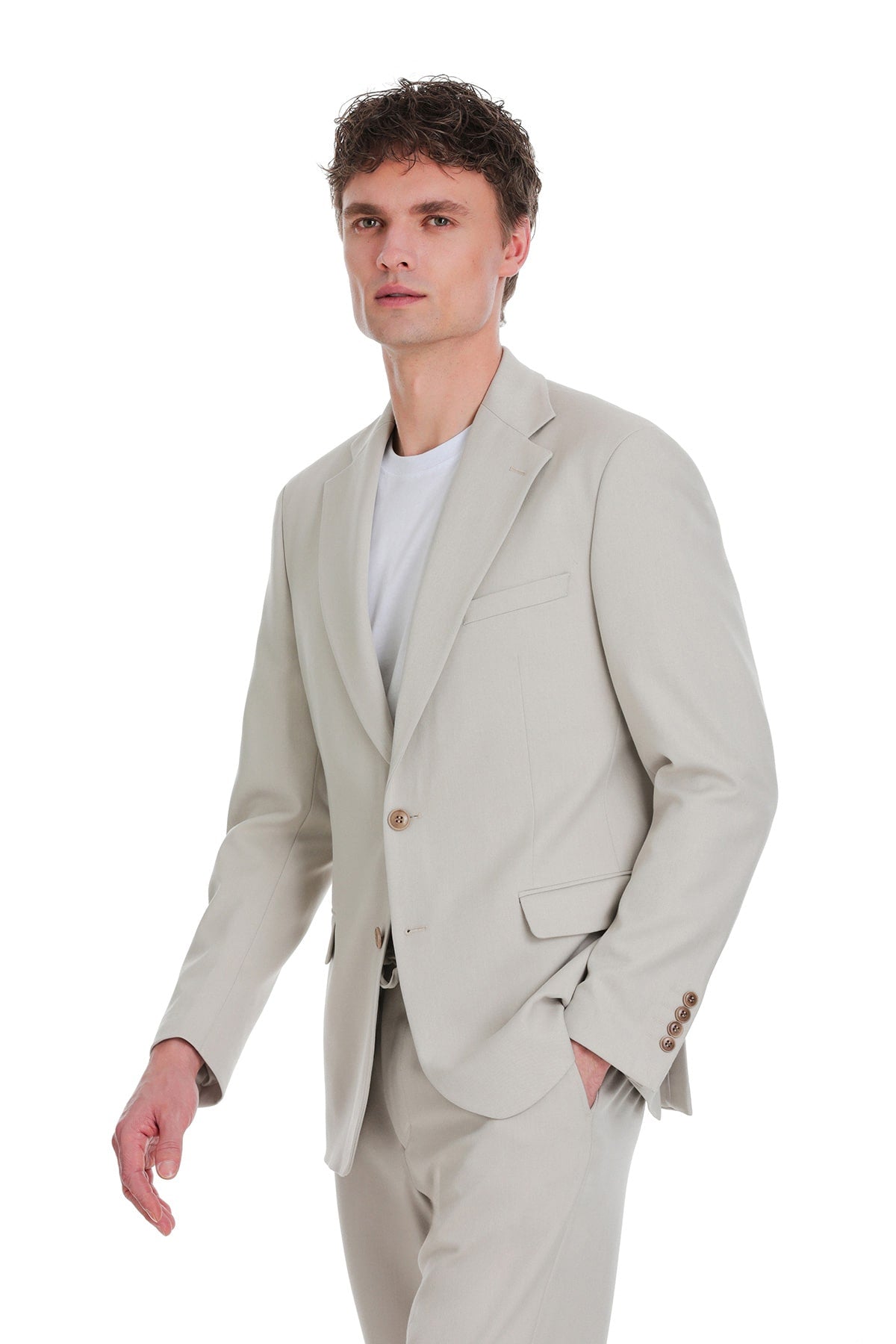A comfort fit beige notch lapel tailored blazer with subtle texture and matching buttons in a single-breasted design