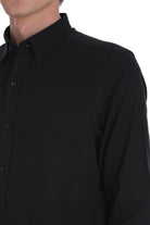 Black long-sleeved button-down shirt with a crisp collar and subtle texture.
