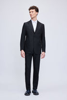 Black tailored suit with a sleek, modern cut and matching trousers.