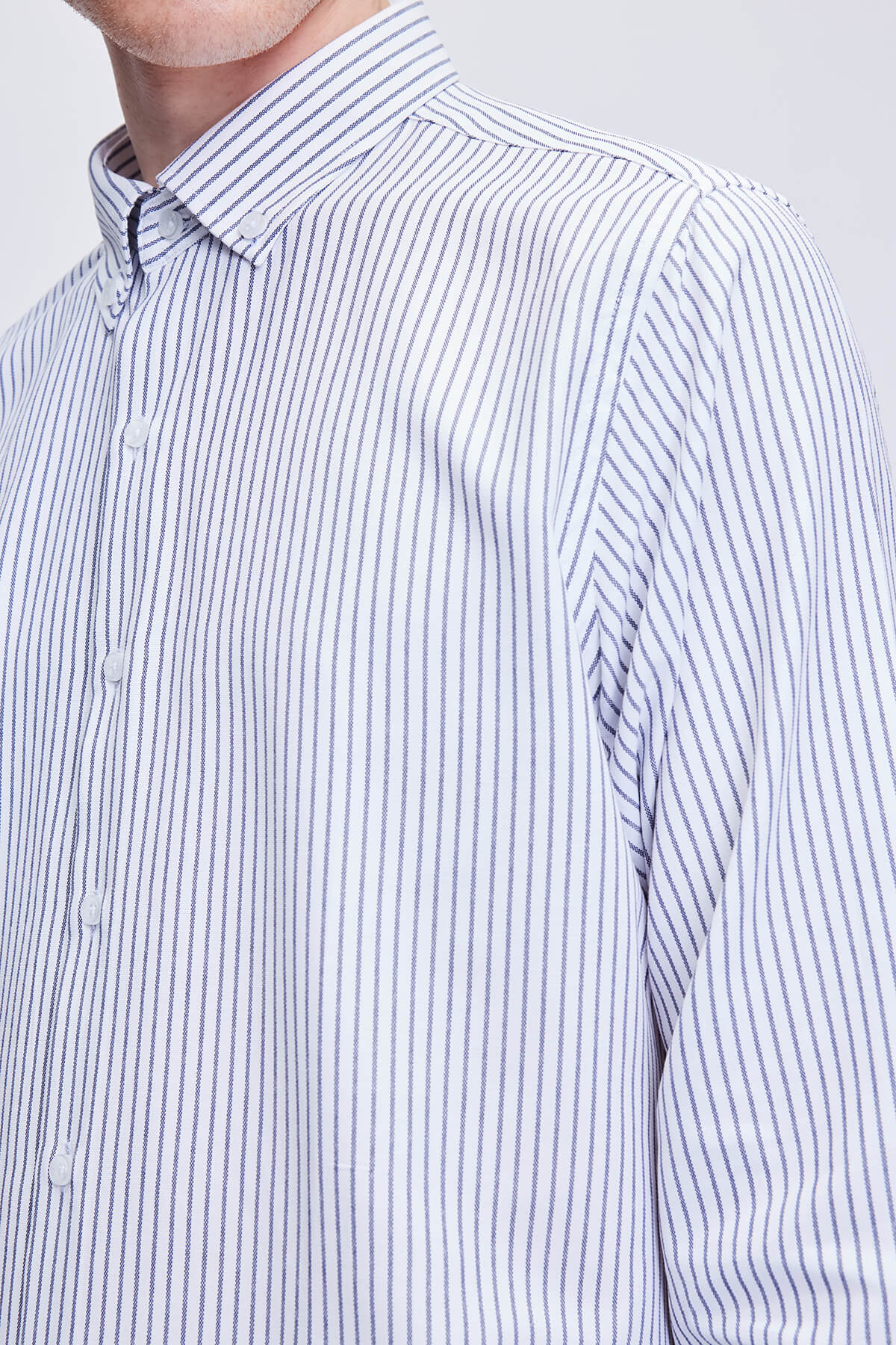 A crisp white and navy blue vertically striped dress shirt with a classic collar.
