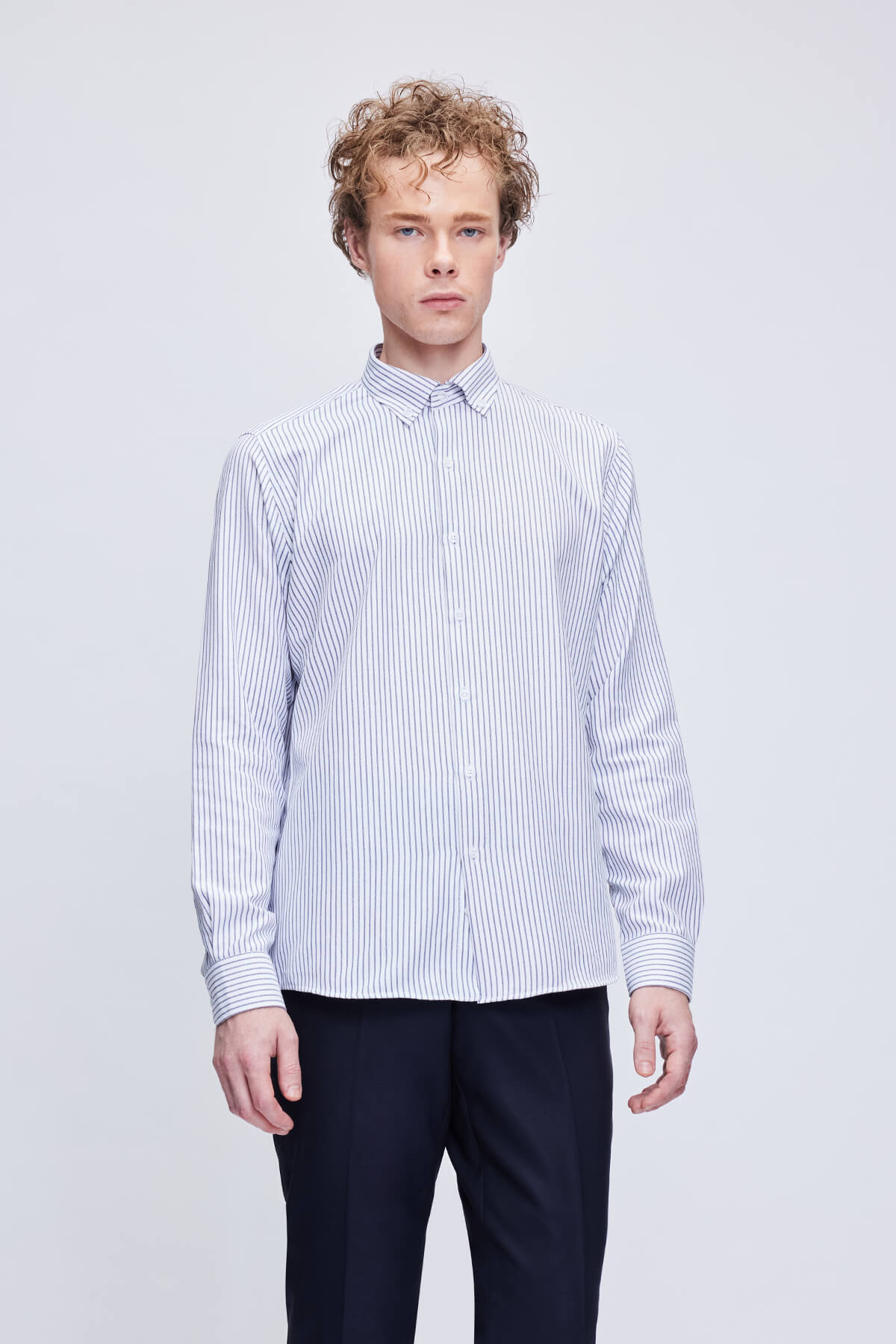 A crisp white and navy blue vertically striped long-sleeved button-down shirt with a classic collar.