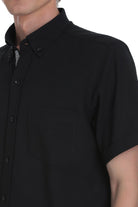 Black short-sleeved button-down shirt with a crisp collar and matching buttons.