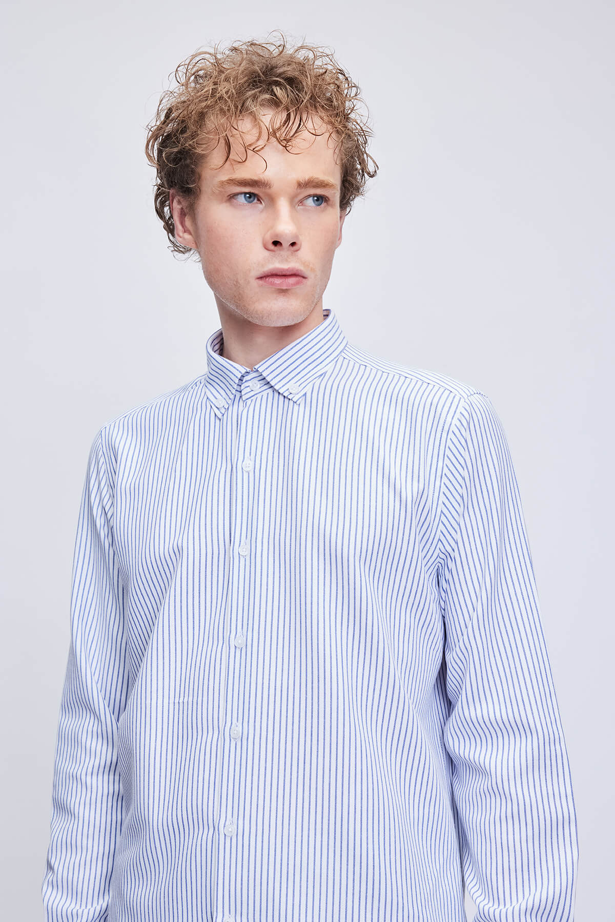 A crisp, long-sleeved button-down shirt in light blue and white vertical stripes.