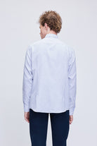 A crisp white and navy blue vertically striped long-sleeved dress shirt with a classic collar.