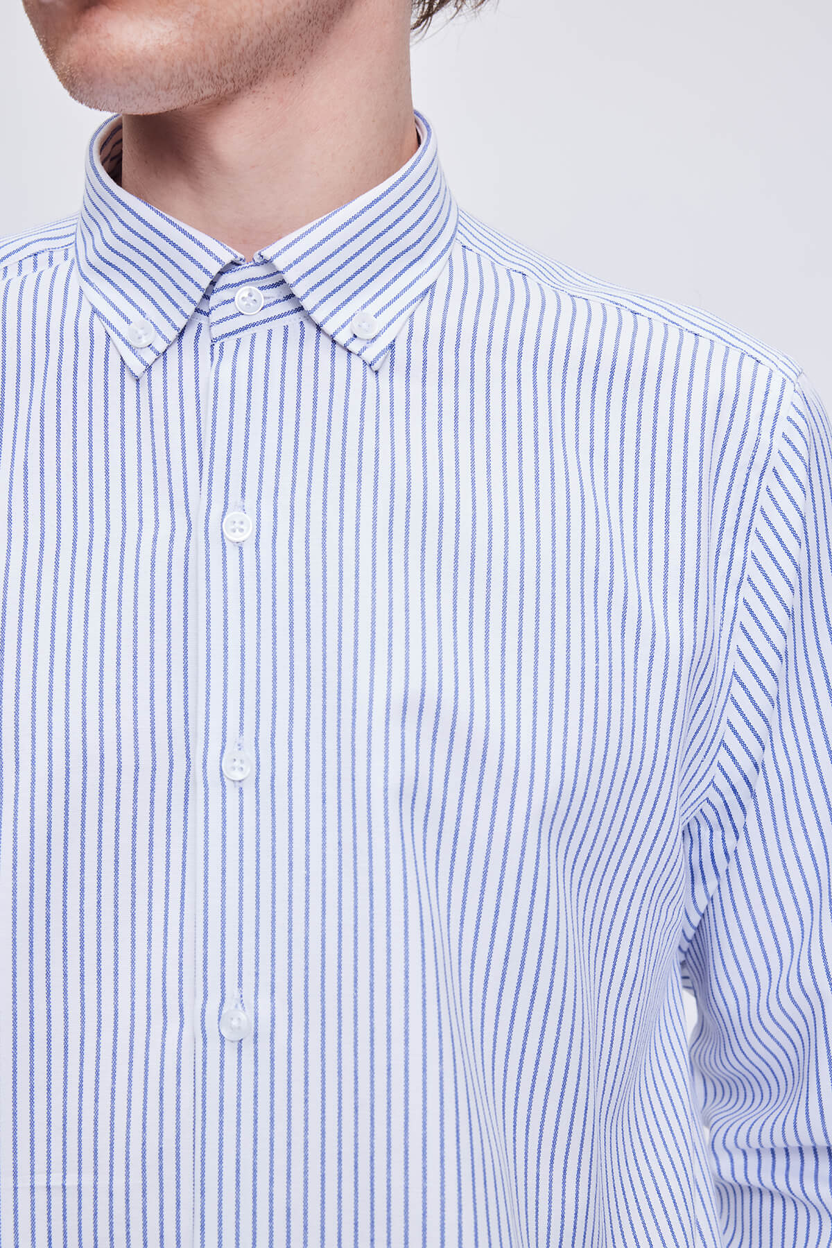 A crisp white and navy blue vertically striped button-down shirt with a classic collar.