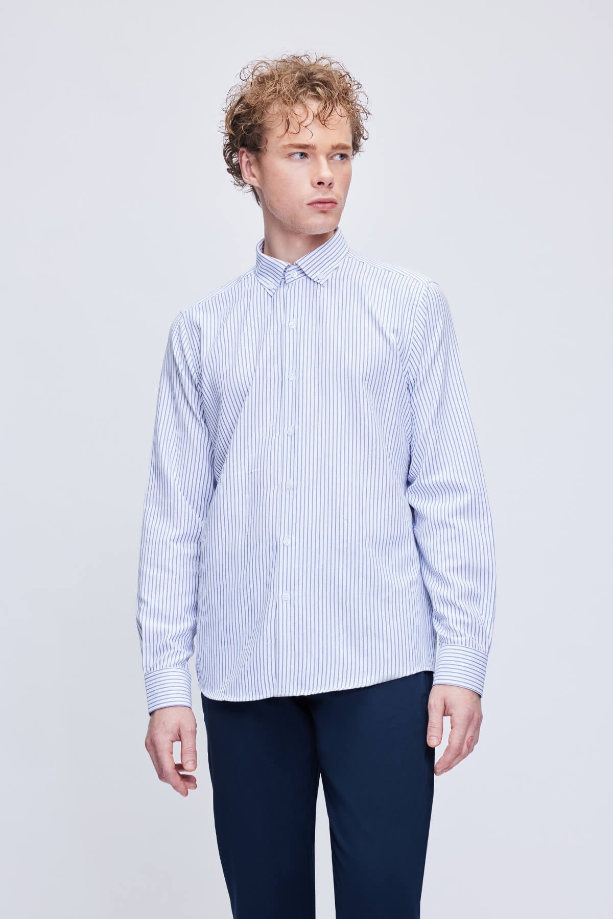 A crisp, long-sleeved button-down shirt in a classic white and navy blue vertical stripe pattern.