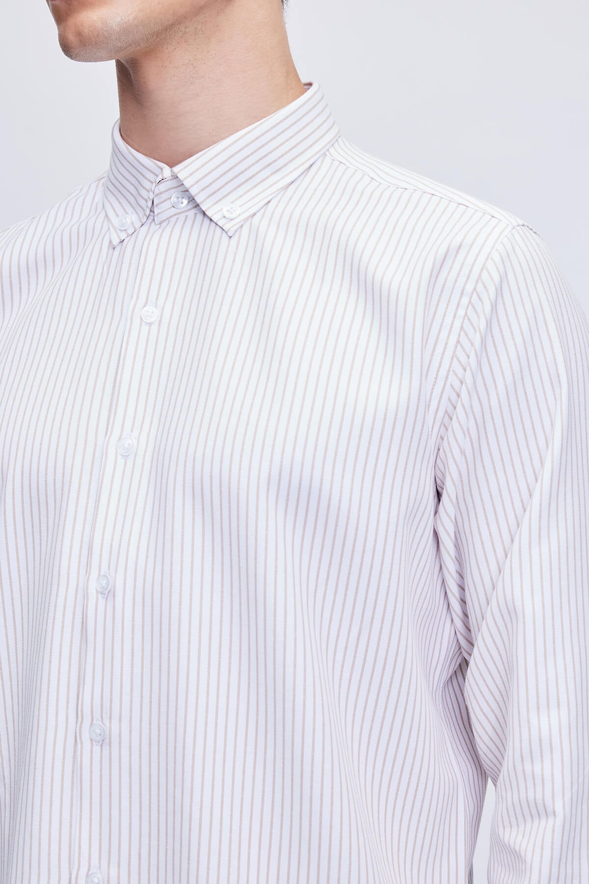 A crisp white button-down shirt with fine gray vertical stripes and a classic collar.