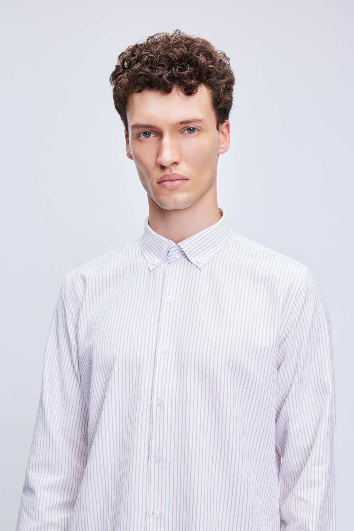 A crisp white button-down shirt with fine vertical gray pinstripes.