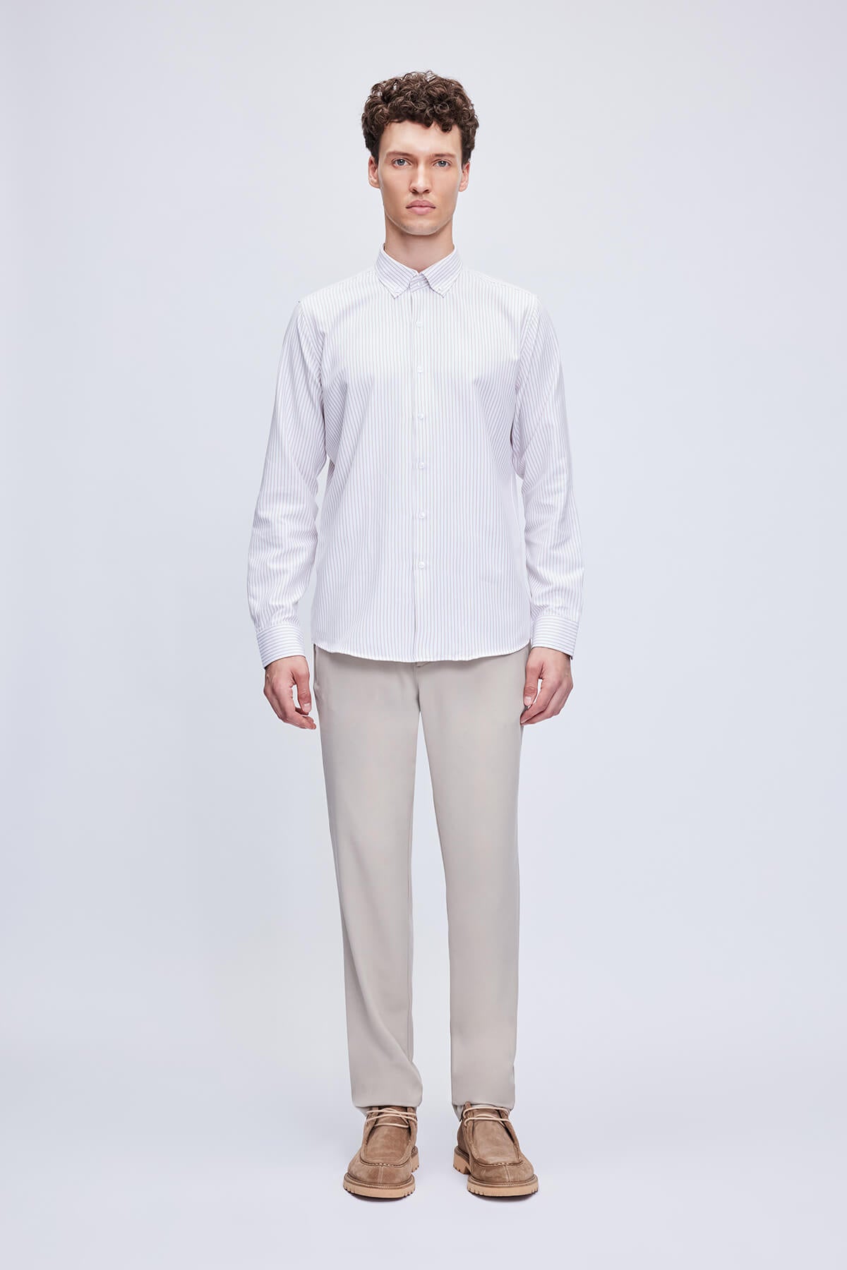 A crisp white long-sleeved button-down shirt with fine vertical stripes.