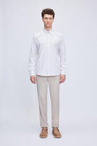 A crisp white long-sleeved button-down shirt with fine vertical stripes.