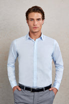 Light blue, long-sleeved men’s dress shirt with a classic collar and button-down front.