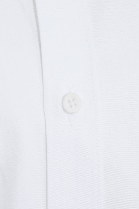 White button with four holes, likely made of plastic or resin.