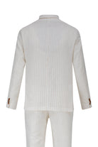 A crisp white pinstripe suit with subtle vertical stripes and matching trousers, featuring brown button accents on the cuffs.