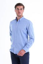 A light blue, long-sleeved button-down shirt with a classic collar and neatly pressed fabric.