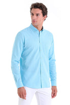 Light blue long-sleeved button-down shirt with a classic collar and chest pocket.