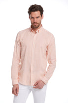 A men’s long-sleeved button-down shirt in soft peach and white vertical stripes, crafted from a lightweight cotton blend with neatly folded cuffs.