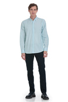 A light blue, long-sleeved button-down shirt with a classic collar and neatly pressed fabric.