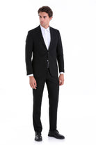 Black tailored suit with a sleek, modern cut and two-button front.