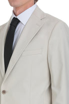 Beige tailored suit jacket with a clean, modern cut and subtle texture.