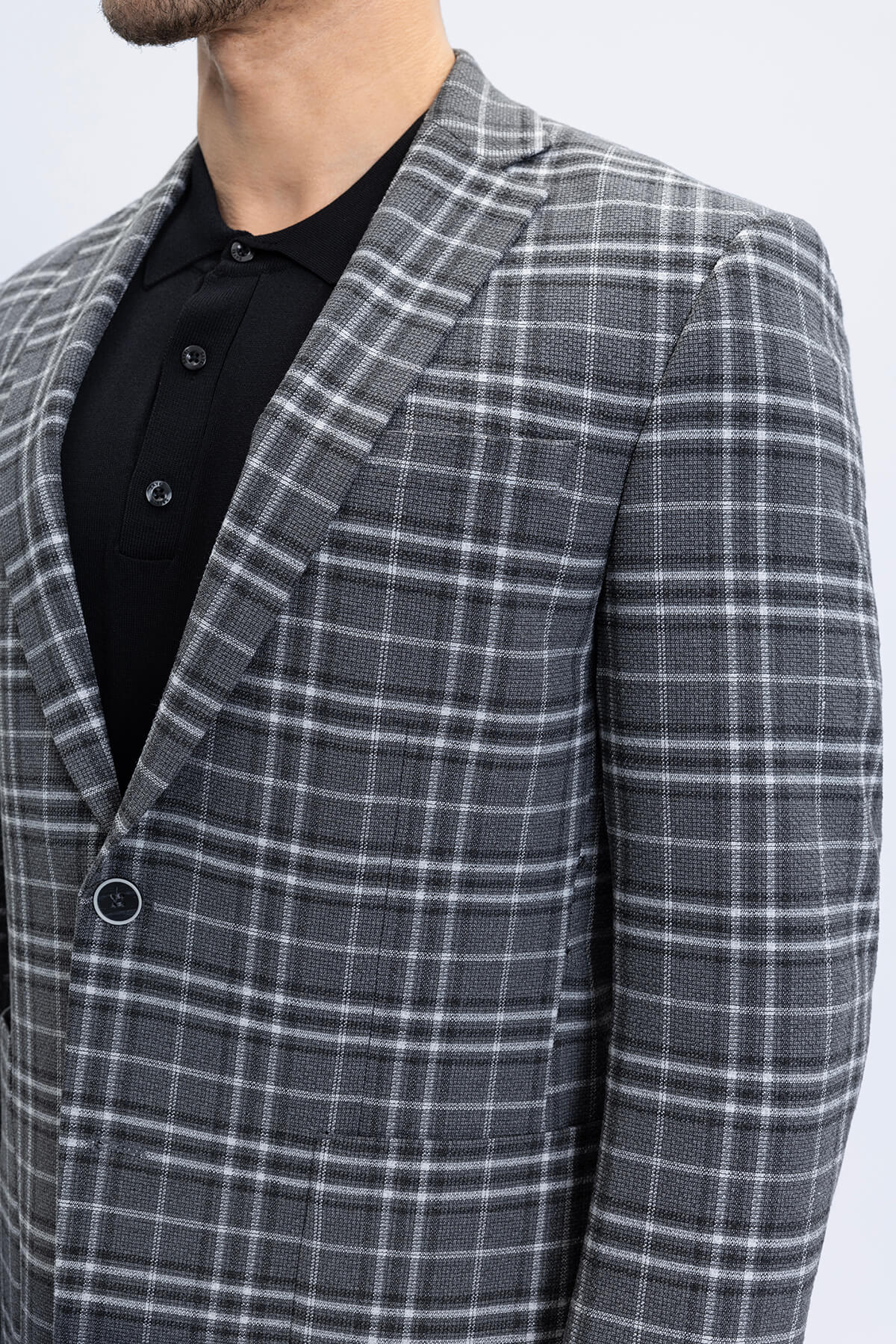 A tailored gray and white plaid blazer featuring a comfort fit notch lapel with a structured classic design