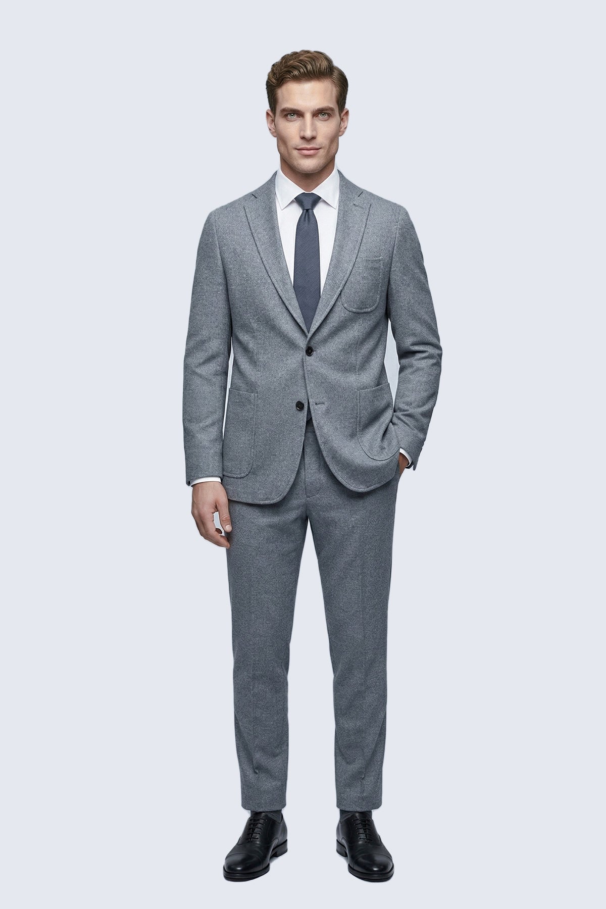 A tailored gray suit with a subtle textured pattern featuring a comfort fit notch lapel two-button jacket and matching trousers