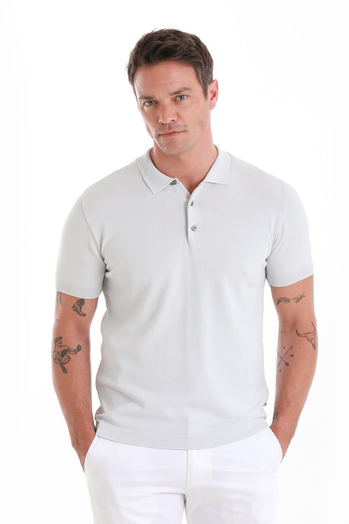A crisp white short-sleeved polo shirt with a classic collar and buttoned placket.