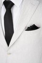 Black satin tie and matching pocket square complement a comfort fit light gray casual suit with notch lapel