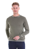 Olive green ribbed knit sweater with white and gray striped trim at the neckline, cuffs, and hem.