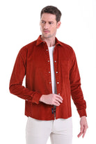 A rich rust-colored corduroy button-up shirt with a classic collar and long sleeves.