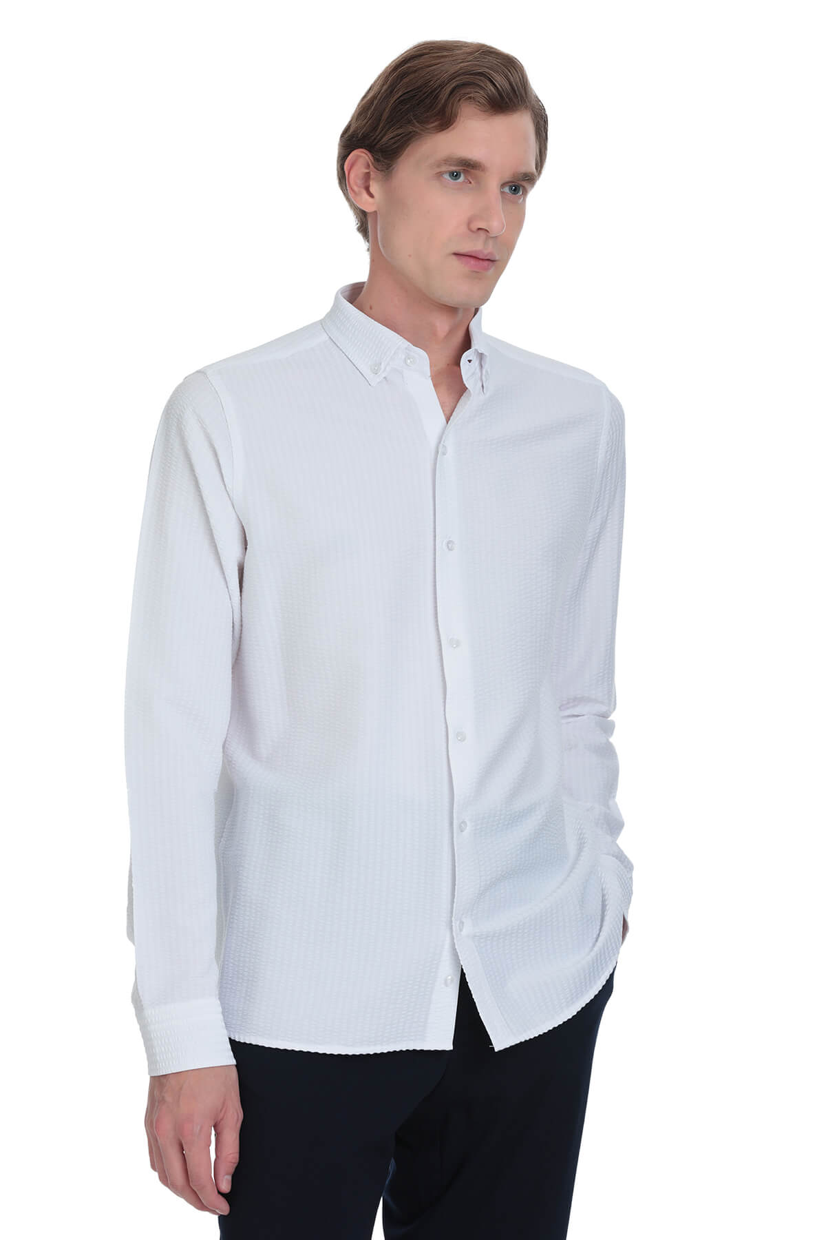 A crisp white long-sleeved button-down shirt with a classic collar and neatly pressed fabric.