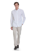 A crisp white long-sleeved button-down shirt with a classic collar and neatly pressed fabric.