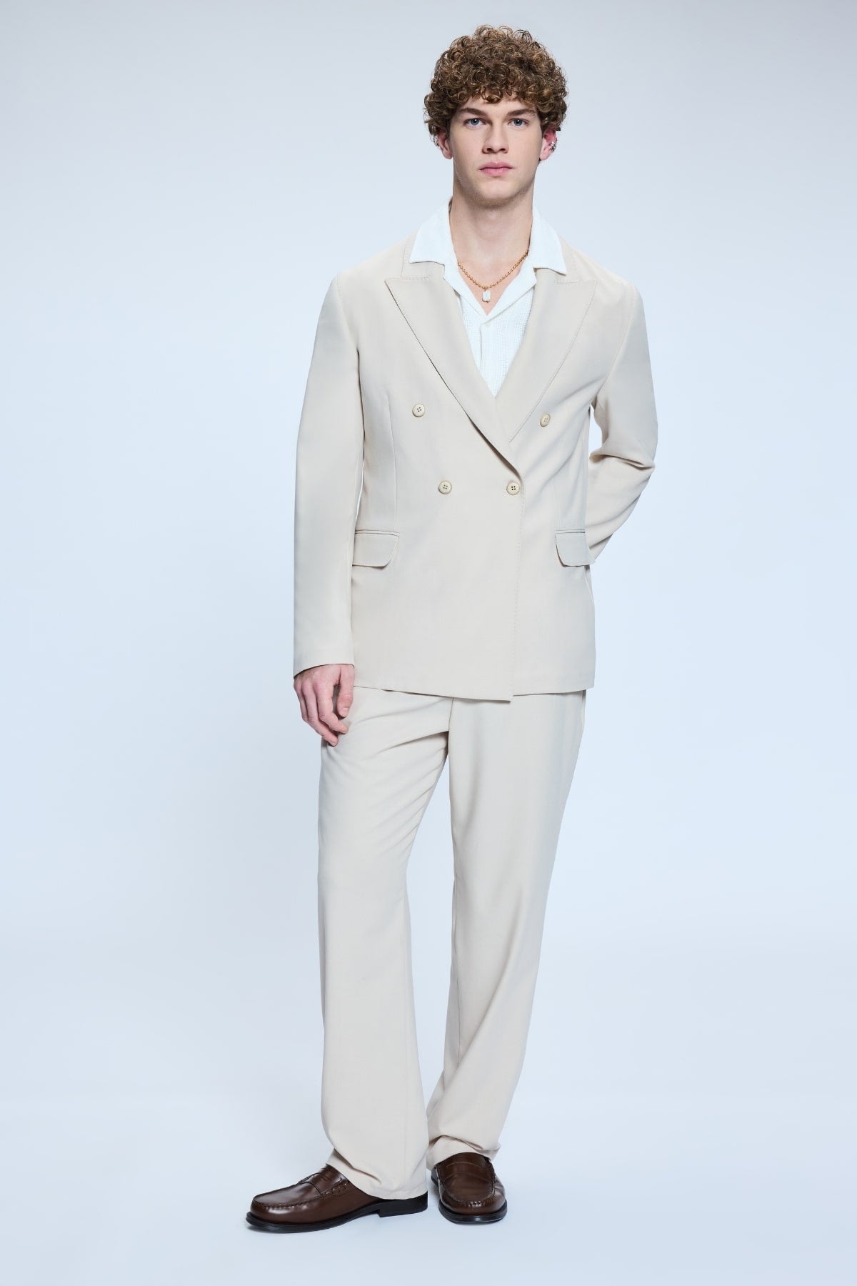 Model wearing cream double-breasted suit