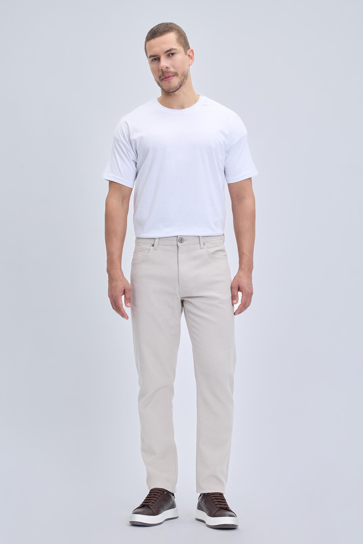 Beige linen-tone dynamic fit chino trousers with pocket low waist and subtle stitching details for smart casual wear