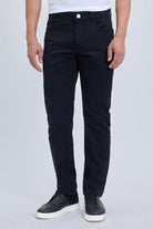 Dynamic fit black cotton gabardine casual pants featuring slim-fit black jeans with classic five-pocket design and white button closure for smart casual dress