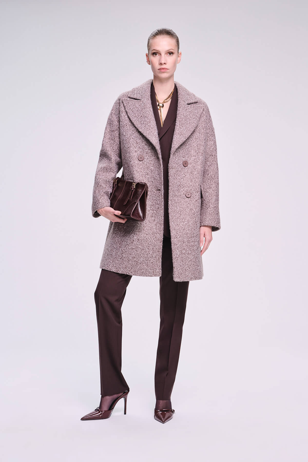 A taupe wool-blend double-breasted coat with a notched collar and buttoned front.